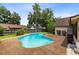 Backyard with lush landscaping has an inground pool with light blue water and a surrounding deck at 7249 Abbey Ln, Winter Park, FL 32792