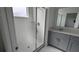 Modern bathroom featuring a glass-enclosed shower, vanity, and neutral tile at 7612 Danube Rd, Kissimmee, FL 34746