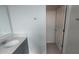 Modern bathroom featuring a gray vanity with solid surface countertop and modern fixtures at 7612 Danube Rd, Kissimmee, FL 34746
