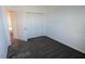 Neutral bedroom with closet, carpet flooring and a door leading to another room at 7612 Danube Rd, Kissimmee, FL 34746