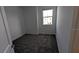 A simplistic bedroom with a window that allows natural light in, along with carpeted floors at 7612 Danube Rd, Kissimmee, FL 34746