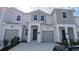 Inviting townhome featuring a modern facade, a private garage, and a well-maintained front yard at 7612 Danube Rd, Kissimmee, FL 34746