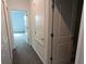 Hallway features carpet flooring, doors, and ample lighting at 7612 Danube Rd, Kissimmee, FL 34746
