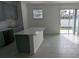 Stylish kitchen featuring stainless steel appliances, island, and sliding glass door at 7612 Danube Rd, Kissimmee, FL 34746