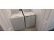 A convenient laundry area features a white washer and dryer set, ready for immediate use at 7612 Danube Rd, Kissimmee, FL 34746