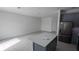 Open-concept living room and kitchen featuring tile flooring and an island at 7612 Danube Rd, Kissimmee, FL 34746