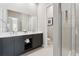 Modern bathroom featuring double vanity sinks, sleek cabinetry, and a glass-enclosed shower at 7740 Sandy Ridge Dr # 216, Reunion, FL 34747