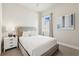 This bedroom features neutral walls, carpeted floors, and a comfortable bed with a window view at 7740 Sandy Ridge Dr # 216, Reunion, FL 34747