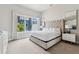 Serene bedroom with a tufted headboard bed, ample natural light, and neutral decor at 7740 Sandy Ridge Dr # 216, Reunion, FL 34747