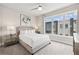 This bedroom features neutral walls, carpeted floors, and a comfortable bed with a large window view at 7740 Sandy Ridge Dr # 216, Reunion, FL 34747