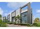 Modern townhome exterior featuring blue and gray siding, with lush landscaping and a contemporary design at 7740 Sandy Ridge Dr # 216, Reunion, FL 34747
