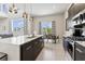 Modern kitchen featuring stainless steel appliances, quartz countertops, and a view to the dining area at 7740 Sandy Ridge Dr # 216, Reunion, FL 34747