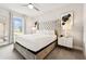 This main bedroom features neutral walls, carpeted floors, and a comfortable bed with a window view at 7740 Sandy Ridge Dr # 216, Reunion, FL 34747