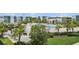 Community oasis: pools, lounge chairs, and lush tropical landscaping at 7740 Sandy Ridge Dr # 216, Reunion, FL 34747