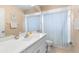 Bright bathroom featuring a vanity with a white countertop and tiled floor at 7760 Indian Ridge N Trl, Kissimmee, FL 34747