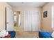 Neutral toned bedroom with closet and views to ensuite bathroom, featuring two beds at 7760 Indian Ridge N Trl, Kissimmee, FL 34747
