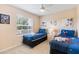 Comfortable bedroom featuring twin beds and themed decor with a ceiling fan at 7760 Indian Ridge N Trl, Kissimmee, FL 34747