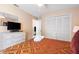 Comfortable bedroom featuring a queen bed, closet space, a dresser with TV, and a ceiling fan at 7760 Indian Ridge N Trl, Kissimmee, FL 34747