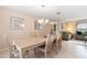 Spacious dining room featuring a chandelier and a view into the living area at 7760 Indian Ridge N Trl, Kissimmee, FL 34747