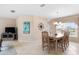 Light-filled dining area with modern decor, including a beautiful art piece at 7760 Indian Ridge N Trl, Kissimmee, FL 34747