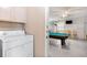 Laundry area with a game room, featuring a pool table and seating at 7760 Indian Ridge N Trl, Kissimmee, FL 34747