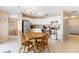 Open kitchen features white cabinets, stainless steel appliances, and adjacent dining area at 7760 Indian Ridge N Trl, Kissimmee, FL 34747