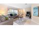 Cozy living room with a large window, comfortable seating, and tile flooring at 7760 Indian Ridge N Trl, Kissimmee, FL 34747