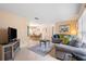 Open-concept living area with tile floors, comfortable seating, and view of dining area at 7760 Indian Ridge N Trl, Kissimmee, FL 34747