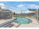 Inviting screened-in pool with lounge chairs and patio seating offers a relaxing outdoor living space at 7760 Indian Ridge N Trl, Kissimmee, FL 34747