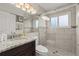 Modern bathroom featuring a glass shower door, granite counters, and a stylish sink at 8522 Blue Horizon Ct, Kissimmee, FL 34747