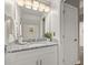 Bright and clean bathroom features a granite countertop vanity, large mirror, and ample lighting at 8522 Blue Horizon Ct, Kissimmee, FL 34747