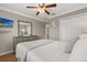 Comfortable bedroom featuring a ceiling fan, flatscreen TV, and ample closet space at 8522 Blue Horizon Ct, Kissimmee, FL 34747