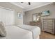 Well-lit bedroom features a white bed, light wood floors, and matching dressers at 8522 Blue Horizon Ct, Kissimmee, FL 34747