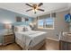 Cozy bedroom featuring wood floors, a ceiling fan, and a window with natural light at 8522 Blue Horizon Ct, Kissimmee, FL 34747