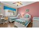 Bedroom with two twin beds, a desk, and a colorful beach-themed decor at 8522 Blue Horizon Ct, Kissimmee, FL 34747