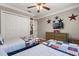 ' bedroom featuring two twin beds, ceiling fan, and neutral walls at 8522 Blue Horizon Ct, Kissimmee, FL 34747