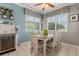 Cozy dining area with a table and chairs next to windows, offering a view of the yard at 8522 Blue Horizon Ct, Kissimmee, FL 34747