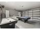 Spacious garage converted into a game room with pool table, air hockey, and storage cabinets at 8522 Blue Horizon Ct, Kissimmee, FL 34747