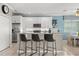 Modern kitchen featuring white cabinetry, stainless steel appliances, and a breakfast bar at 8522 Blue Horizon Ct, Kissimmee, FL 34747