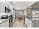 Modern kitchen featuring granite countertops, stainless steel appliances, and tile flooring at 8522 Blue Horizon Ct, Kissimmee, FL 34747