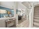 Bright living room and dining room with tile floors and staircase with landing at 8522 Blue Horizon Ct, Kissimmee, FL 34747