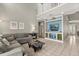 Open-concept living room features neutral paint, large sectional sofa, and built in entertainment center at 8522 Blue Horizon Ct, Kissimmee, FL 34747