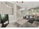 Living room with neutral walls, carpeted floor, and comfortable gray sofa near stairway at 8522 Blue Horizon Ct, Kissimmee, FL 34747