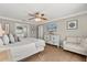 Comfortable bedroom featuring a ceiling fan, light wood floors, and a white dresser with a TV at 8522 Blue Horizon Ct, Kissimmee, FL 34747