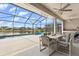 Inviting screened-in patio with ceiling fans and a view of the pool and lake at 8522 Blue Horizon Ct, Kissimmee, FL 34747