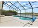 Sparkling pool and lake view from screened-in patio for outdoor enjoyment at 8522 Blue Horizon Ct, Kissimmee, FL 34747