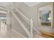 Carpeted staircase with white railing leading to the second floor with large mirror at 8522 Blue Horizon Ct, Kissimmee, FL 34747