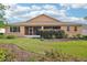 A lush green backyard with well-manicured landscaping and a screened-in patio at 8932 Sw 101St Cir, Ocala, FL 34481
