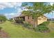 Side view of a well-kept backyard with a green lawn and lovely shrubbery at 8932 Sw 101St Cir, Ocala, FL 34481