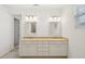 Bathroom featuring double vanity, quartz countertops and two sinks at 8932 Sw 101St Cir, Ocala, FL 34481